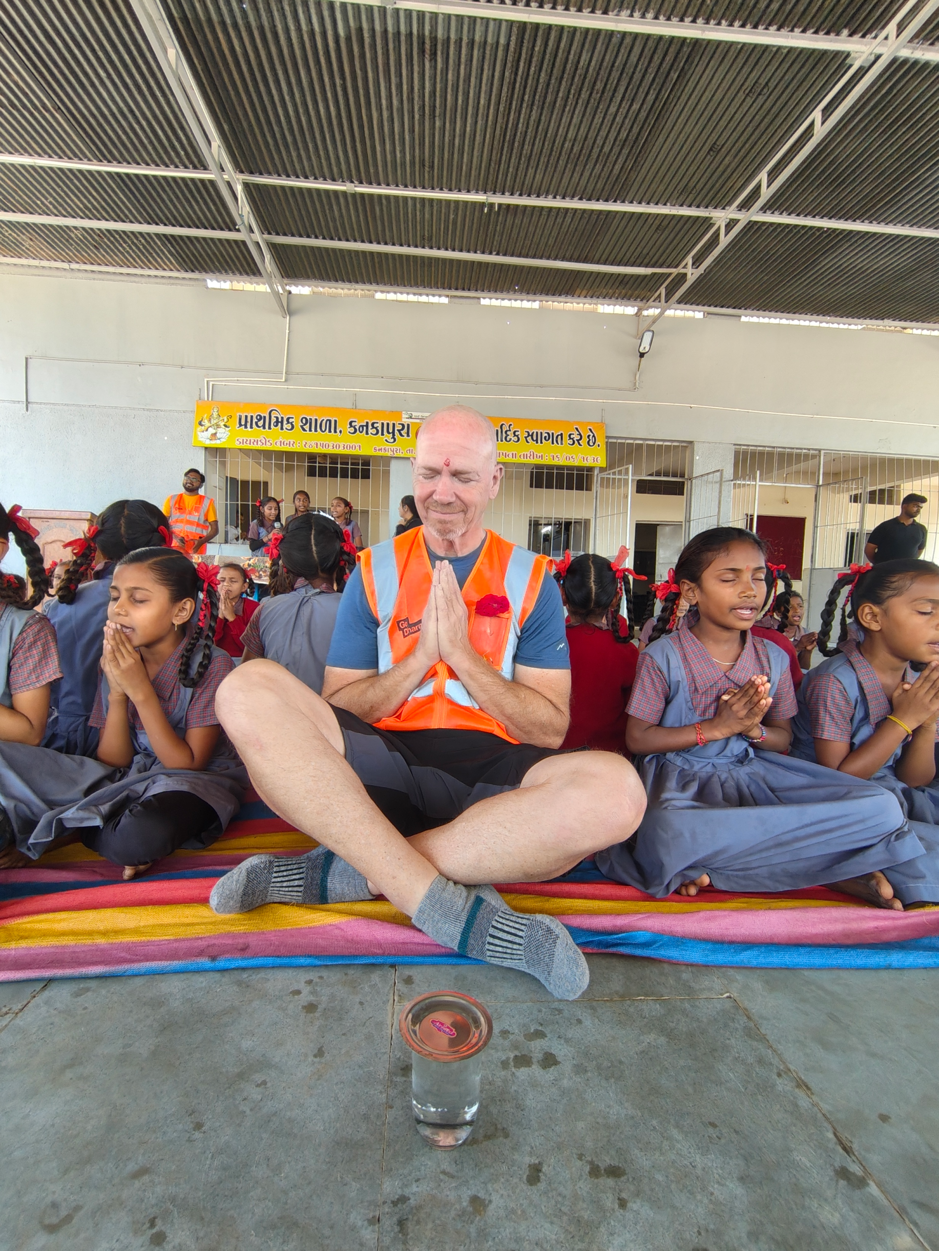 Ron sitting in prayer with students in India